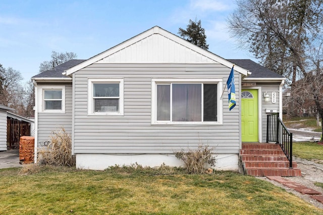 bungalow-style home featuring a front yard