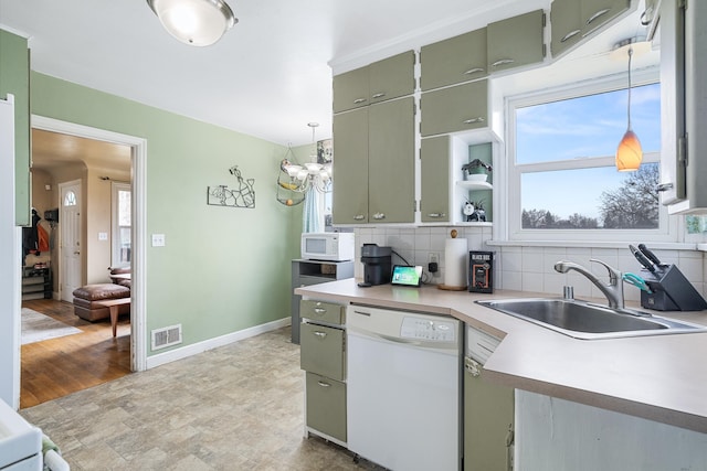 kitchen with sink, white appliances, decorative light fixtures, and decorative backsplash