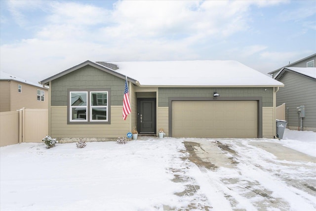 view of front of property featuring a garage and fence