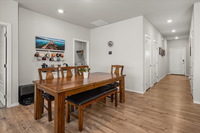 dining room with recessed lighting, baseboards, visible vents, and light wood finished floors