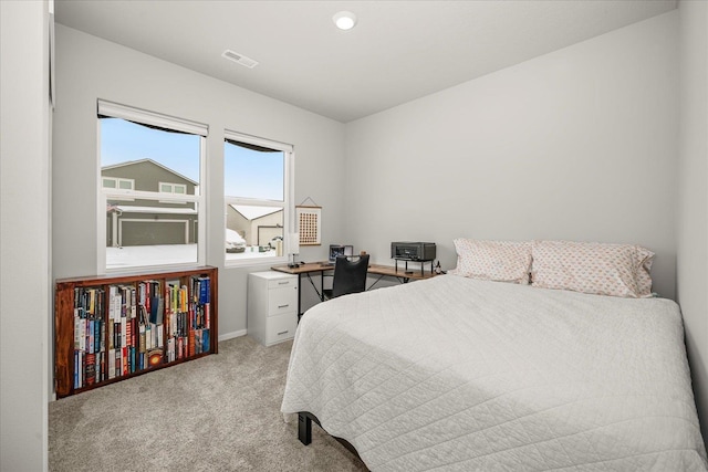 bedroom featuring light colored carpet, visible vents, and baseboards