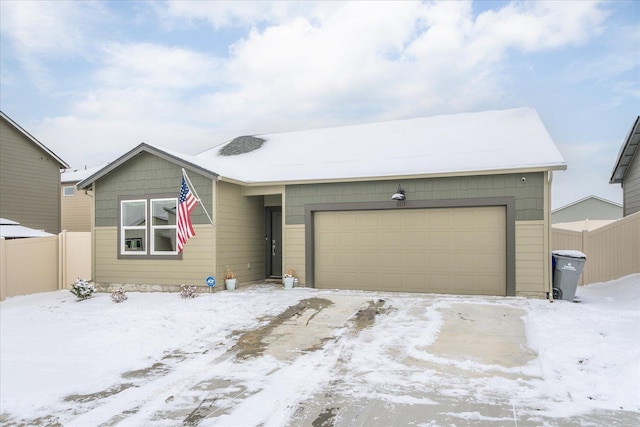 view of front of property featuring a garage and fence