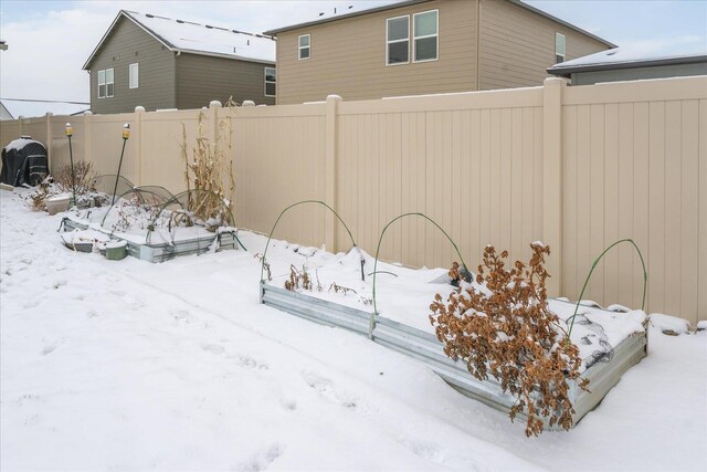 yard covered in snow with fence