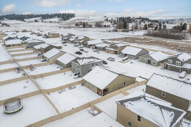 snowy aerial view featuring a residential view