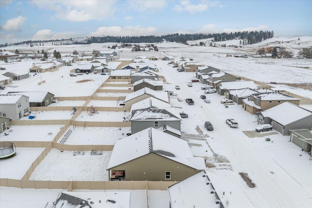 snowy aerial view with a residential view