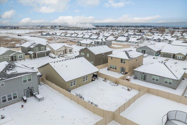 snowy aerial view with a residential view