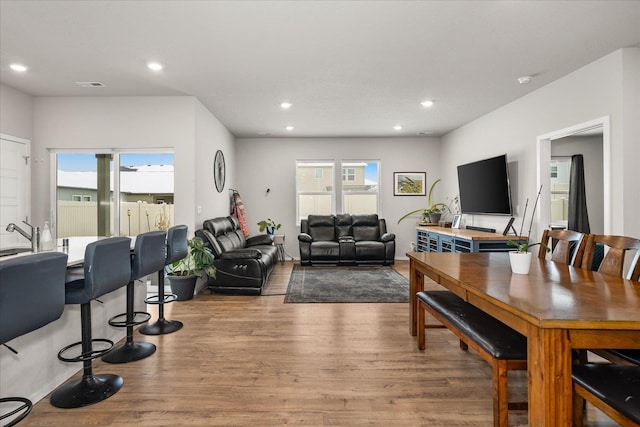 dining space with a healthy amount of sunlight, visible vents, wood finished floors, and recessed lighting