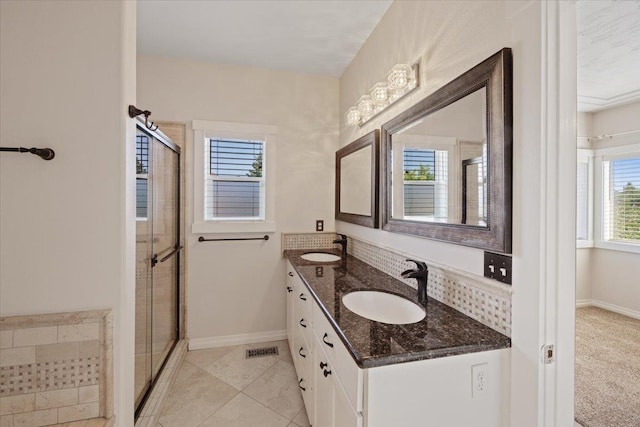 bathroom featuring vanity, tile patterned floors, and a shower with shower door