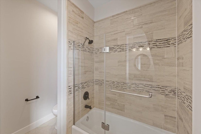 bathroom with tile patterned floors, toilet, and combined bath / shower with glass door