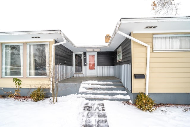 view of snow covered property entrance