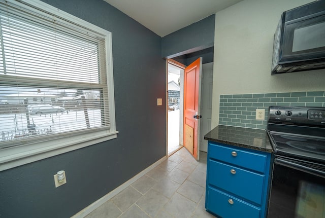 kitchen with backsplash, dark stone counters, light tile patterned floors, black appliances, and blue cabinetry