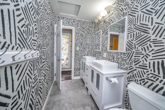 bathroom featuring vanity, toilet, and a textured ceiling