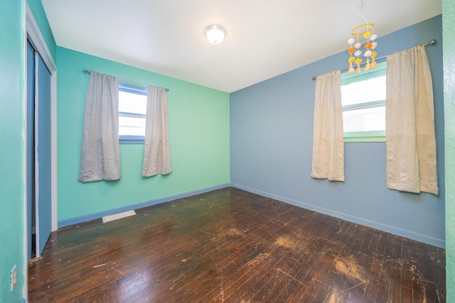 spare room featuring dark wood-type flooring