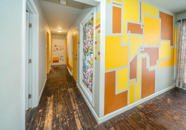 hallway with dark hardwood / wood-style flooring