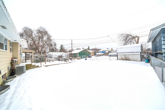 yard layered in snow featuring cooling unit