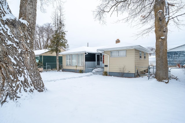 view of snow covered rear of property