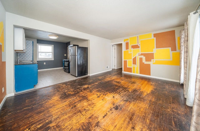 unfurnished living room featuring wood-type flooring