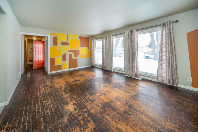 empty room with dark wood-type flooring