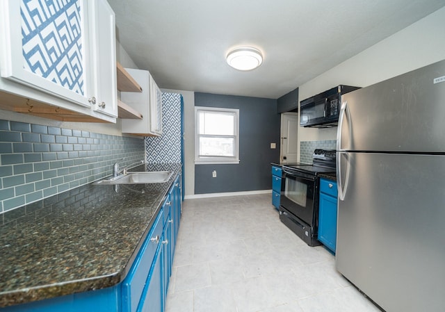 kitchen featuring tasteful backsplash, sink, dark stone counters, black appliances, and blue cabinetry