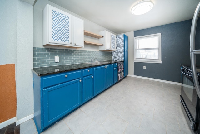 kitchen with sink, blue cabinetry, tasteful backsplash, white cabinets, and black range oven