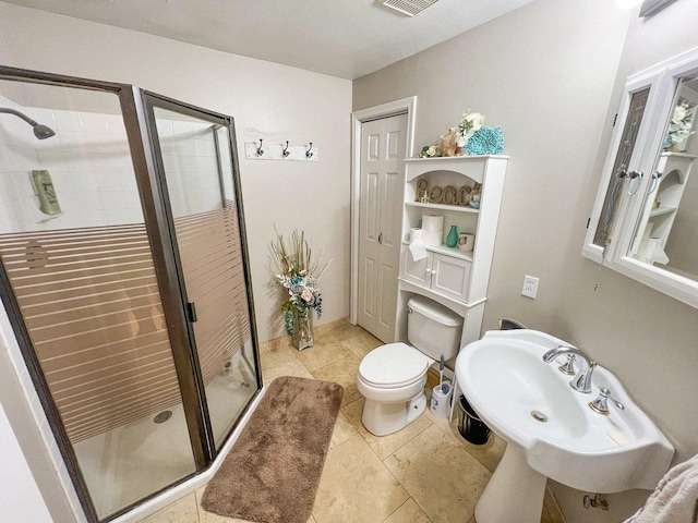 bathroom featuring a shower stall, tile patterned flooring, visible vents, toilet, and a sink