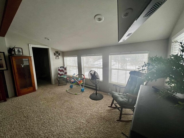 sitting room featuring vaulted ceiling and carpet