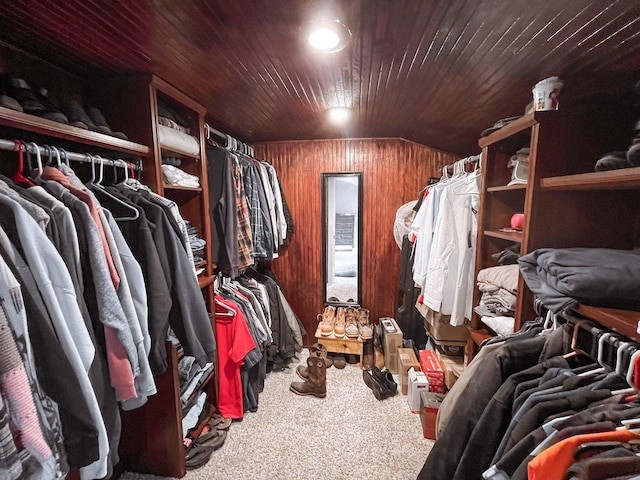 walk in closet featuring carpet flooring and lofted ceiling