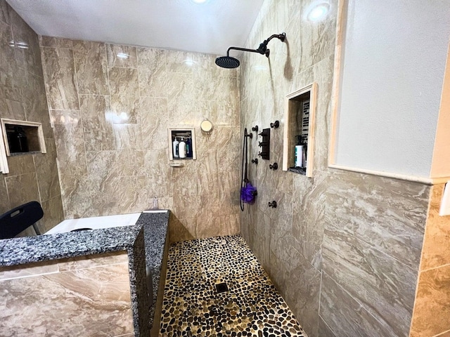 bathroom featuring tile walls and tiled shower
