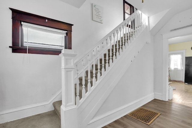 stairway with hardwood / wood-style floors