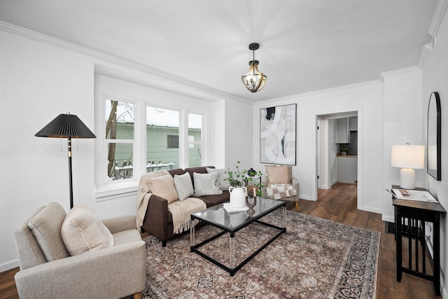 living room with an inviting chandelier, ornamental molding, and dark hardwood / wood-style floors