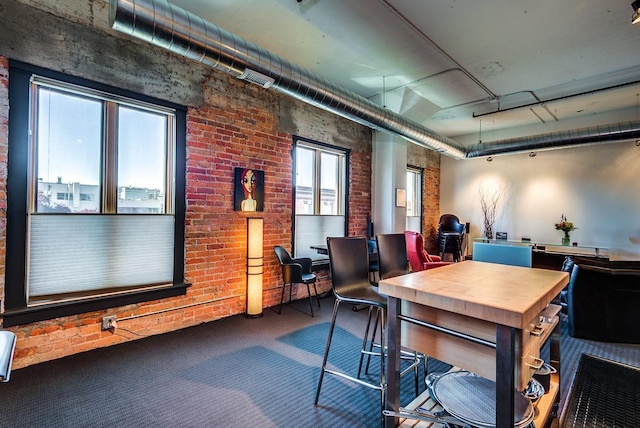 carpeted office with brick wall