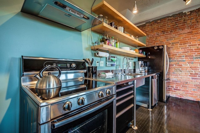 kitchen with brick wall, sink, exhaust hood, and electric stove