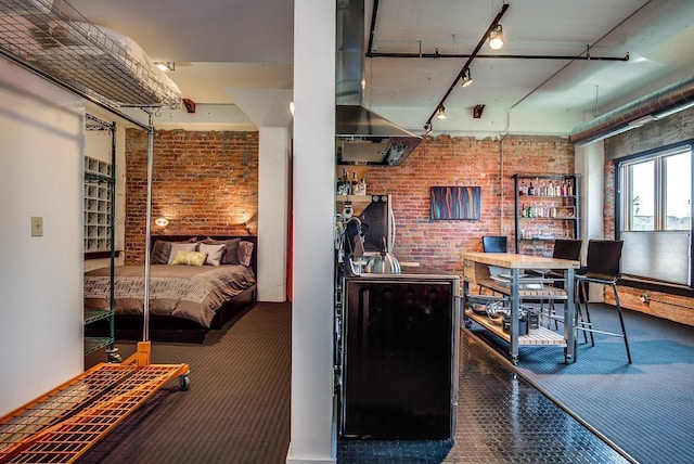 interior space with track lighting and brick wall