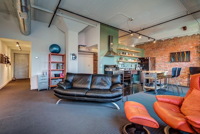 living room featuring brick wall and rail lighting