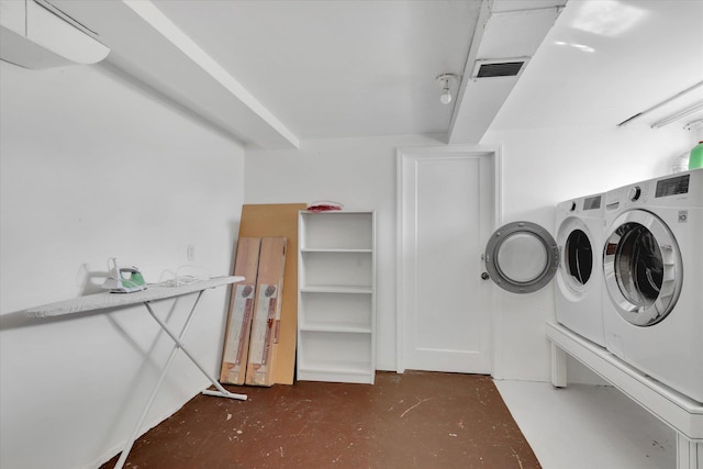 washroom featuring visible vents and washer and dryer