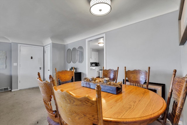 dining area with washing machine and dryer and visible vents