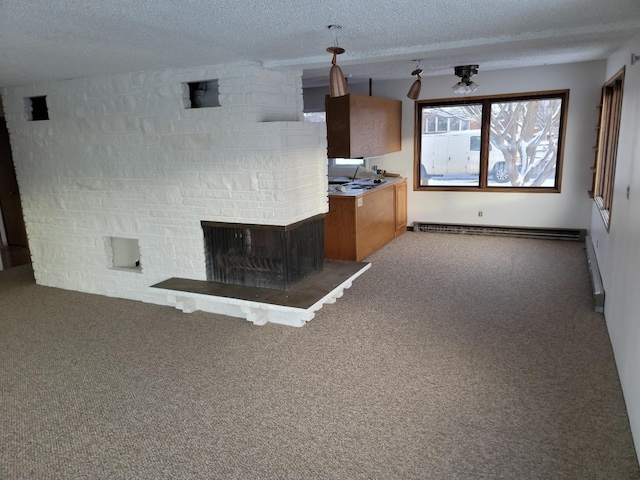 unfurnished living room with carpet, a textured ceiling, and baseboard heating