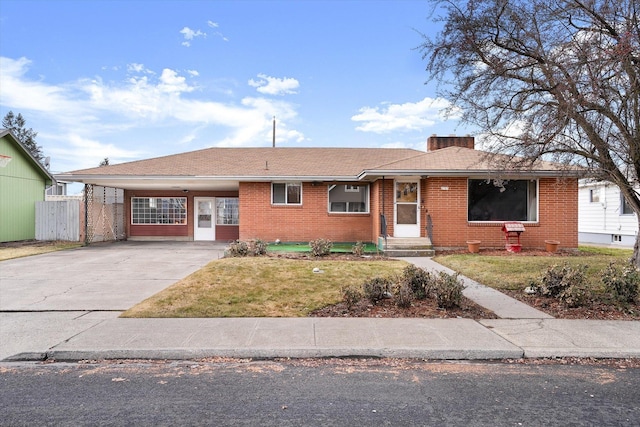 ranch-style house with a carport and a front yard