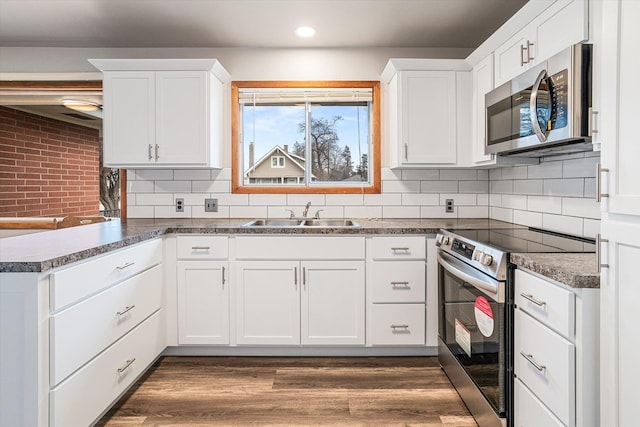 kitchen featuring stainless steel appliances, sink, and white cabinets