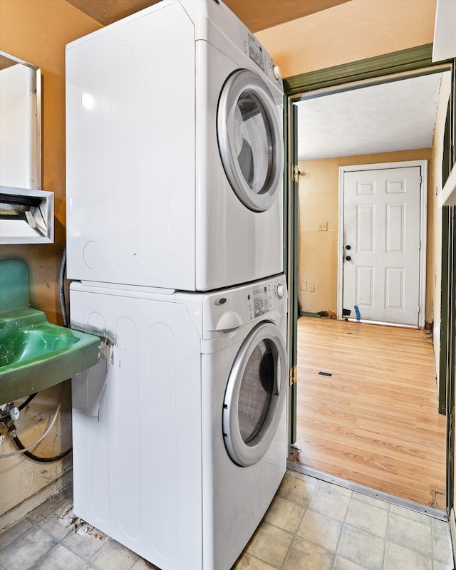 laundry room with stacked washer and dryer