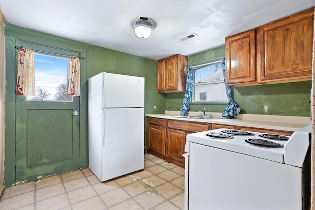 kitchen featuring sink and white appliances