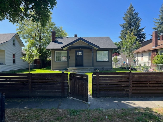 bungalow-style house with a front lawn