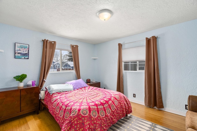 bedroom featuring hardwood / wood-style floors and a textured ceiling