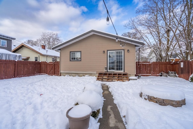 view of snow covered rear of property