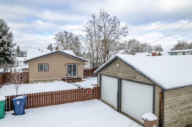 view of snow covered garage