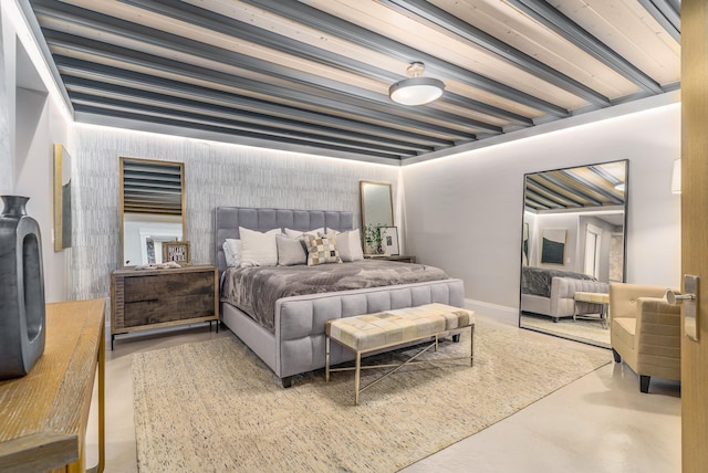 bedroom with concrete floors and beam ceiling