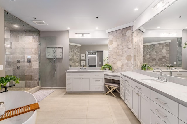 bathroom featuring vanity, a shower with door, tile patterned floors, and tile walls