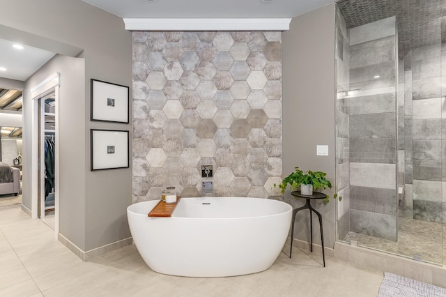 bathroom featuring tile patterned floors, shower with separate bathtub, and tile walls