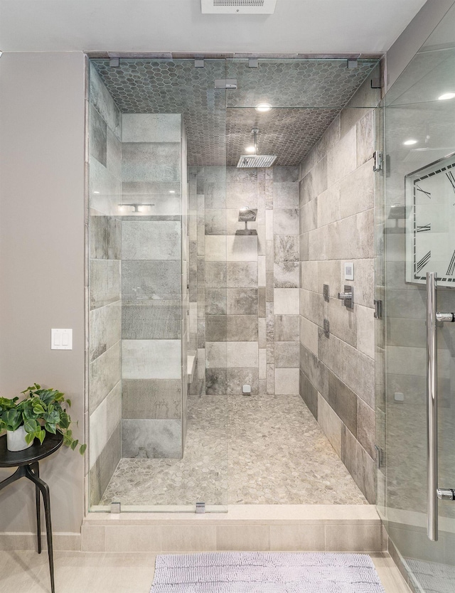 bathroom featuring a shower with door