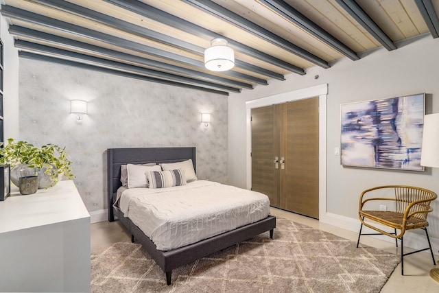 bedroom featuring a closet and beamed ceiling